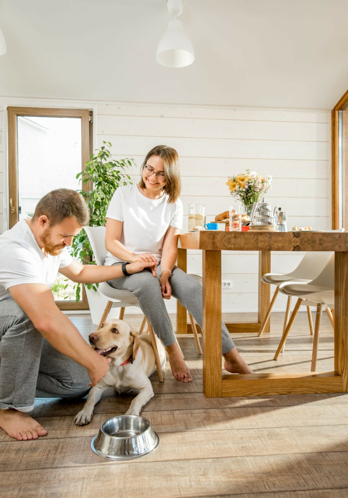 Young couple with dog at home | River City Flooring